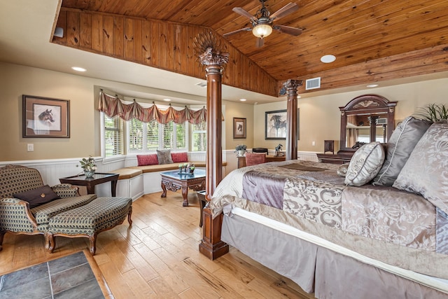 2559 Palm Deer Dr, Loxahatchee, FL 33470 - bedroom with wood ceiling, light wood-type flooring, vaulted ceiling, ornate columns, and wainscoting