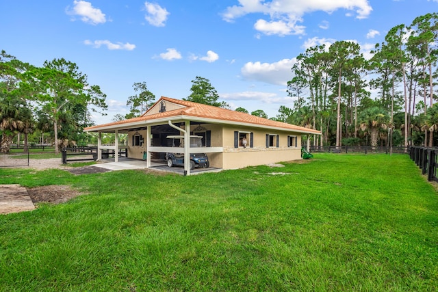 back of house featuring a yard and a patio