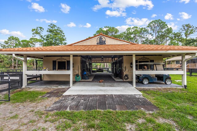 2559 Palm Deer Dr, Loxahatchee, FL 33470 - view of parking featuring an attached carport and an exterior structure