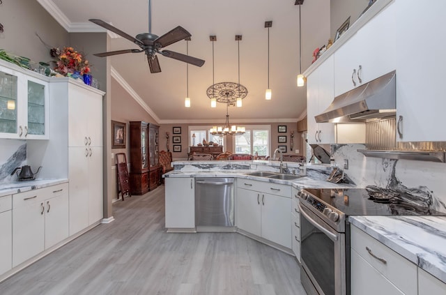 kitchen featuring appliances with stainless steel finishes, sink, pendant lighting, white cabinets, and light hardwood / wood-style floors