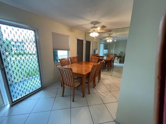 tiled dining space with ceiling fan