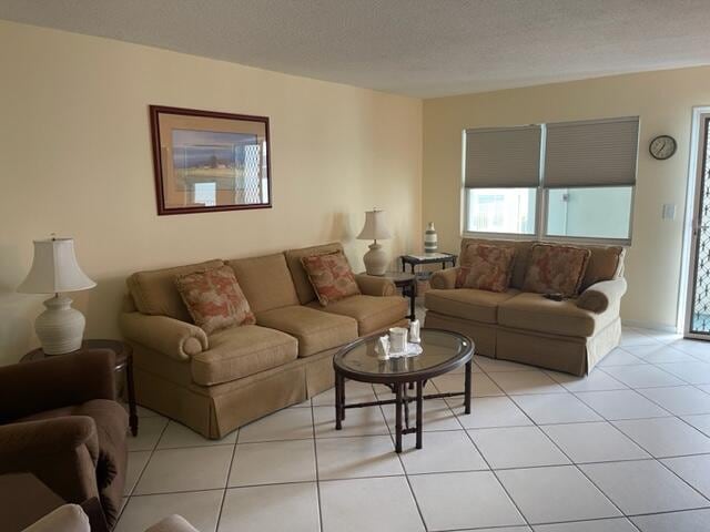 living room featuring light tile floors and a textured ceiling