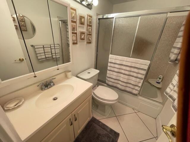 bathroom with toilet, tile flooring, and vanity with extensive cabinet space