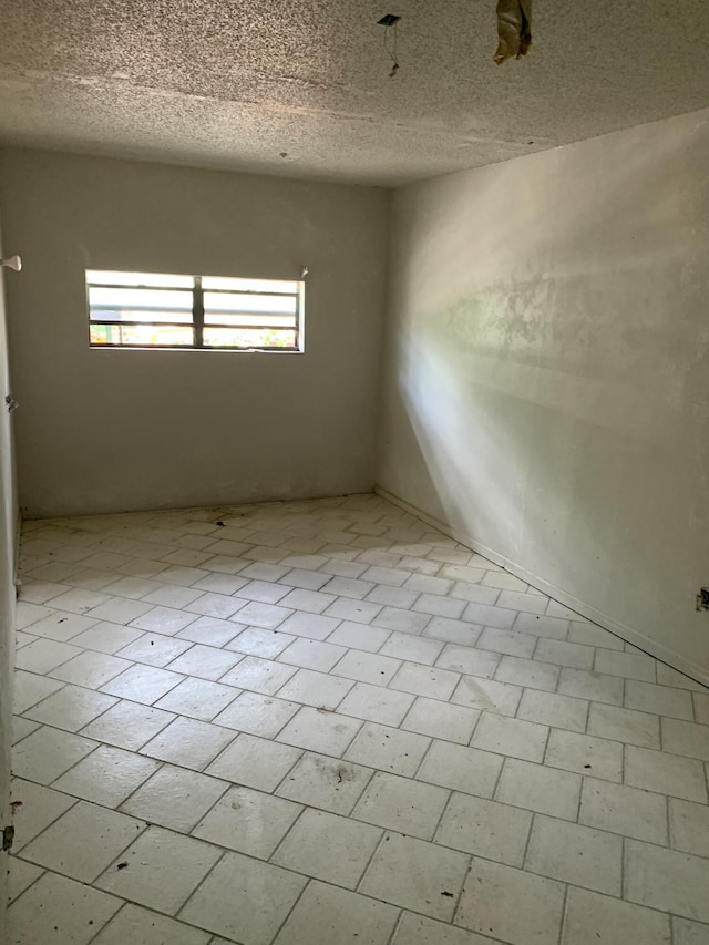 empty room with a textured ceiling