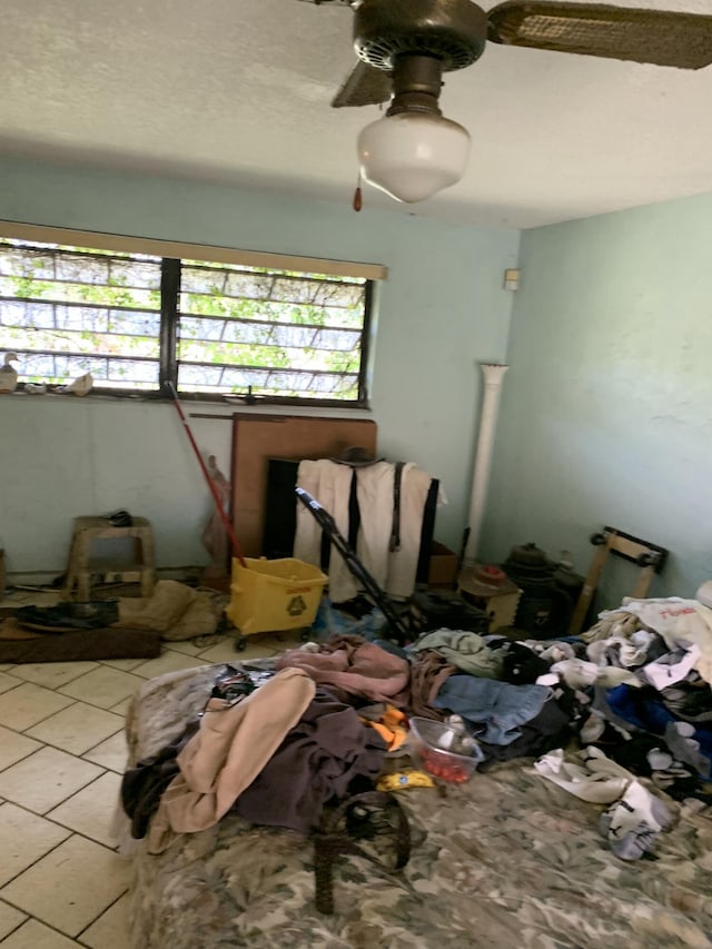 unfurnished bedroom with tile patterned floors and ceiling fan