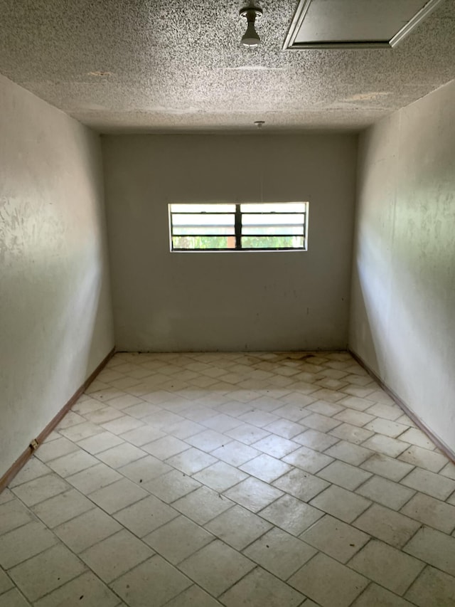 spare room featuring a textured ceiling