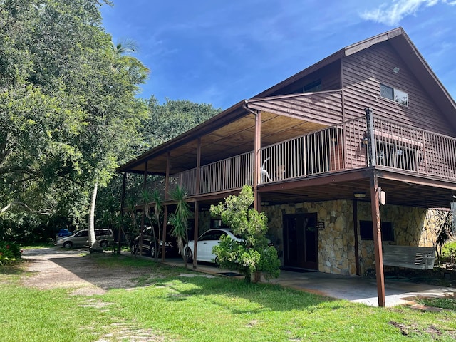 back of house with a lawn and a wooden deck