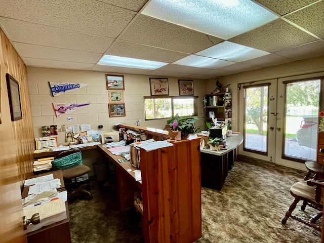 carpeted office featuring a paneled ceiling and french doors