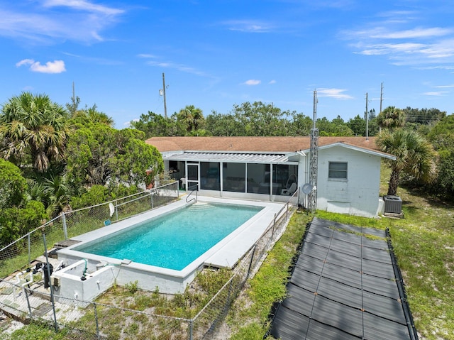 view of swimming pool featuring central air condition unit and a patio