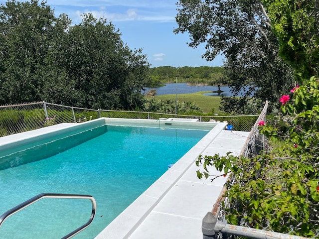 view of pool featuring a water view