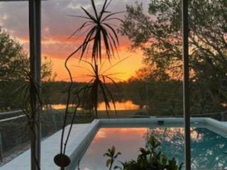 view of pool at dusk