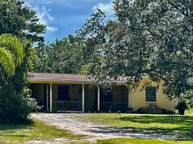 view of front of property with a porch and a front yard