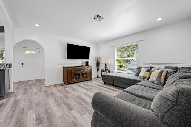 422 49th St, West Palm Beach, FL 33407 - living room featuring ornamental molding, light wood finished floors, arched walkways, and recessed lighting