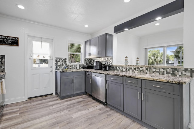 422 49th St, West Palm Beach, FL 33407 - kitchen with gray cabinetry, stainless steel dishwasher, ornamental molding, backsplash, and light wood-style flooring