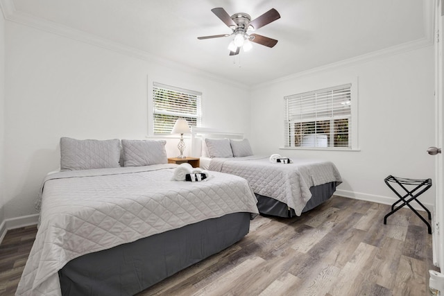 422 49th St, West Palm Beach, FL 33407 - bedroom featuring ornamental molding, wood finished floors, baseboards, and a ceiling fan