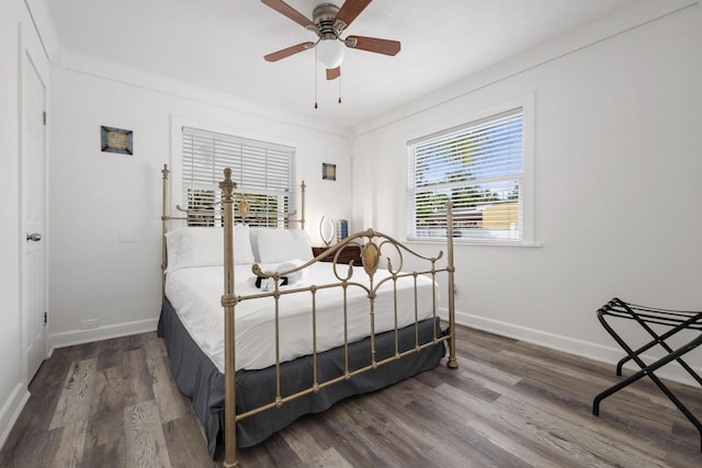422 49th St, West Palm Beach, FL 33407 - bedroom featuring wood finished floors, baseboards, and a ceiling fan
