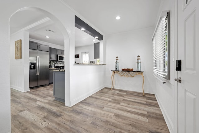 422 49th St, West Palm Beach, FL 33407 - kitchen featuring stainless steel appliances, light wood-style floors, gray cabinetry, crown molding, and recessed lighting