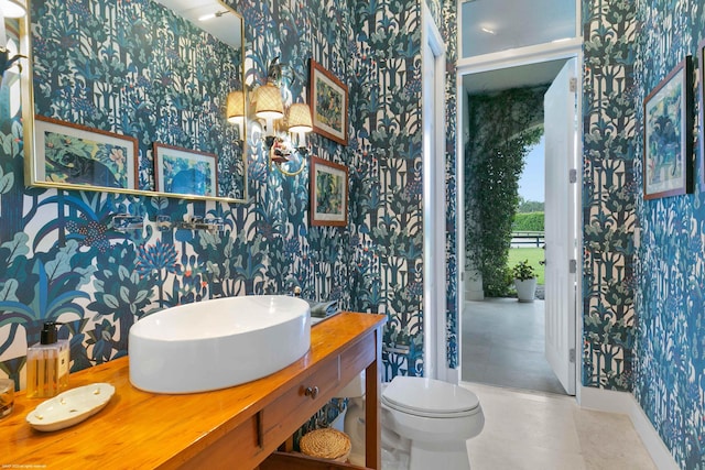 bathroom featuring toilet, tile floors, and vanity