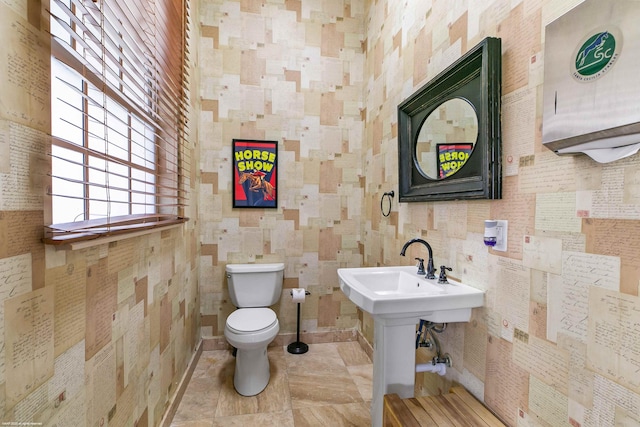 bathroom featuring toilet and tile flooring