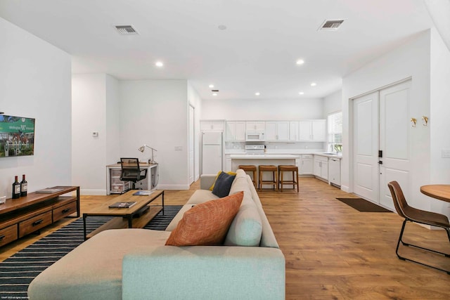 living room with light hardwood / wood-style flooring