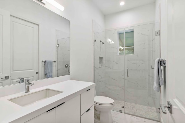 bathroom with tile floors, toilet, vanity, and a shower with door