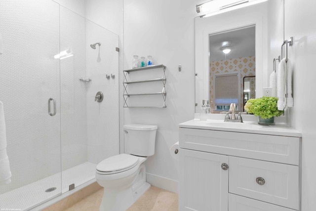 bathroom featuring toilet, vanity, a shower with shower door, and tile flooring