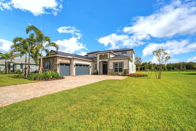 view of front of house featuring a garage and a front lawn