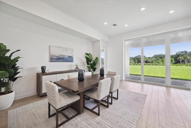 dining space with light hardwood / wood-style floors