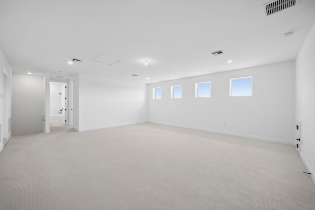 unfurnished room featuring light carpet