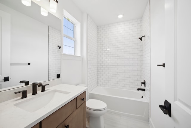 full bathroom with toilet, tile floors, tiled shower / bath combo, and large vanity