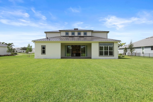 rear view of house with a lawn