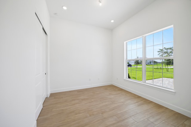 empty room with light hardwood / wood-style flooring