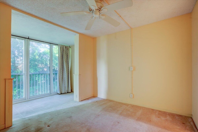 carpeted empty room featuring a textured ceiling and ceiling fan