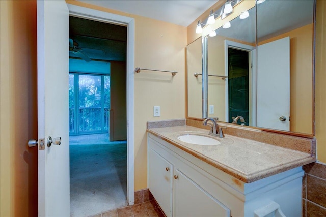 bathroom with tile patterned flooring, ceiling fan, and vanity