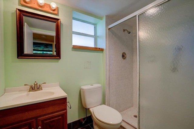 bathroom featuring vanity, toilet, and an enclosed shower