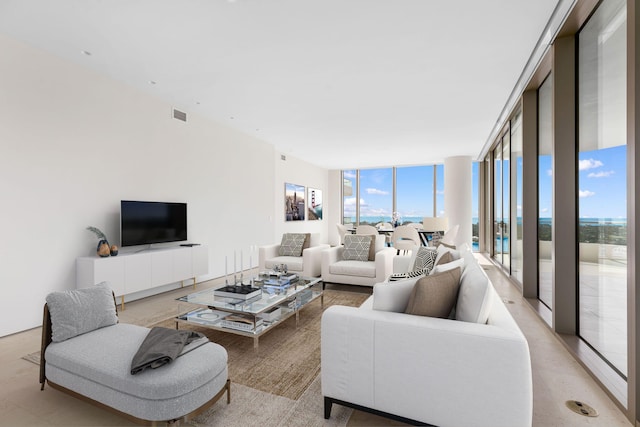 living room featuring plenty of natural light and a wall of windows