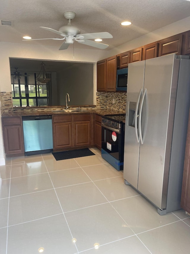 kitchen with backsplash, stainless steel appliances, ceiling fan, sink, and light tile patterned flooring