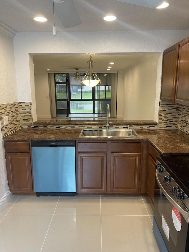 kitchen with light tile patterned floors, sink, appliances with stainless steel finishes, and tasteful backsplash