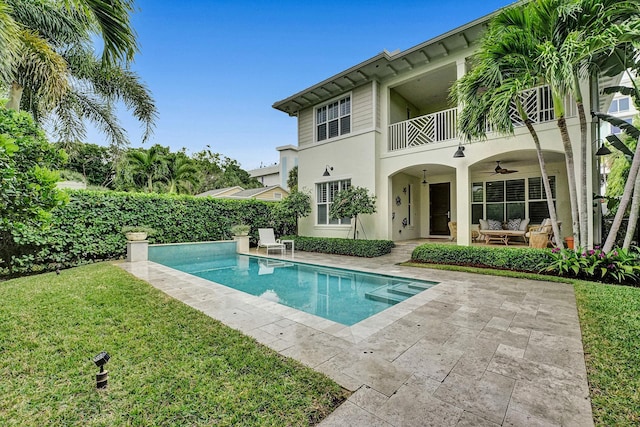 view of swimming pool with a yard, a patio area, and ceiling fan