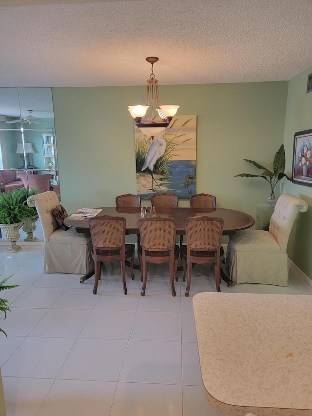 dining area with a chandelier, visible vents, a textured ceiling, and tile patterned floors