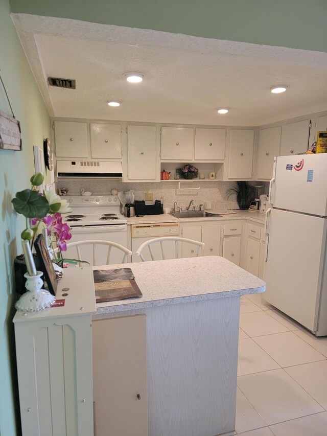 bathroom with toilet, vanity, and tile flooring