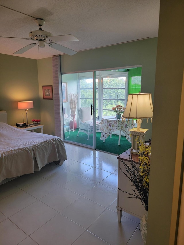 bedroom with access to exterior and a textured ceiling