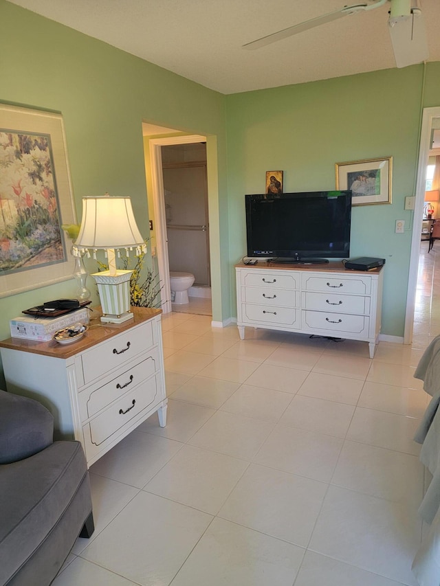 living area with light tile patterned flooring and baseboards