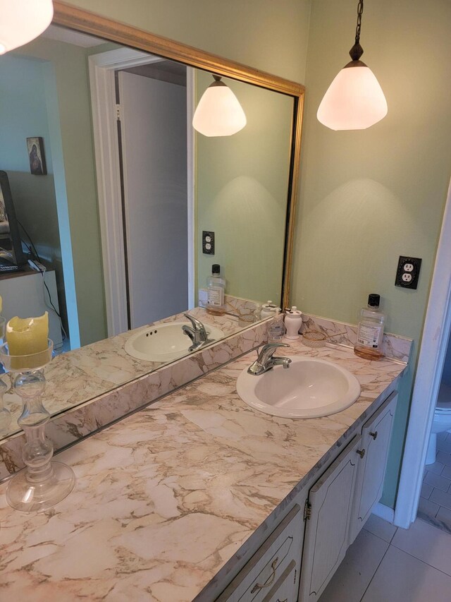 bathroom featuring tile flooring and vanity with extensive cabinet space