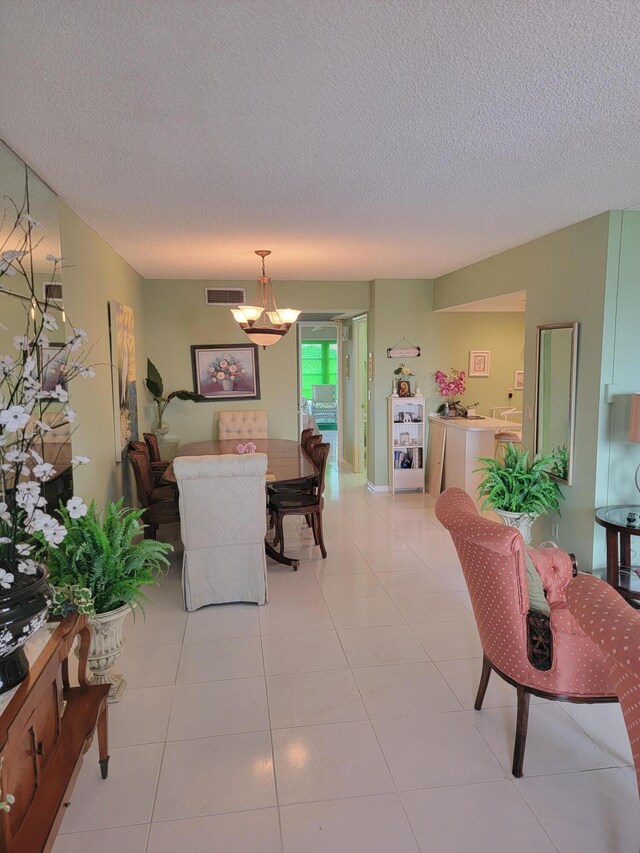 living room featuring a textured ceiling, ceiling fan, and light tile floors