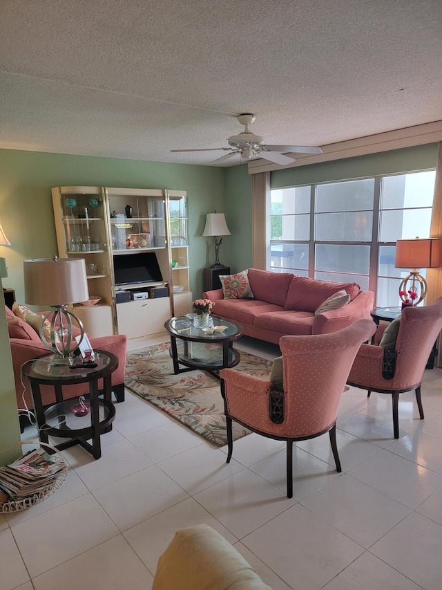 living area with a textured ceiling and a ceiling fan