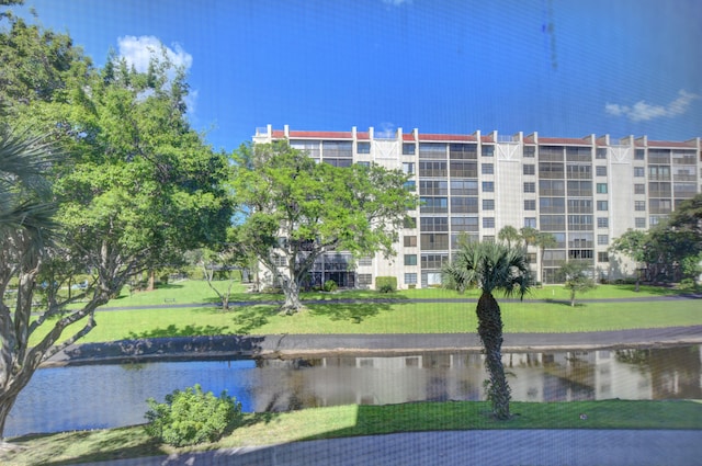 view of home's community featuring a water view and a yard