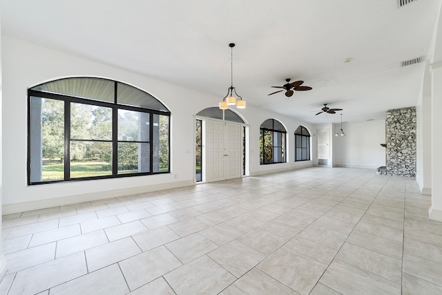 tiled spare room with ceiling fan