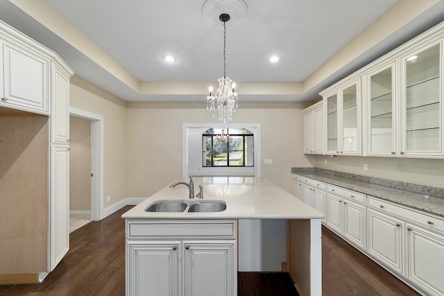 kitchen featuring an inviting chandelier, white cabinets, dark wood-type flooring, and sink