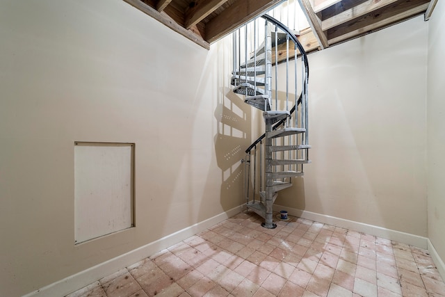 stairway featuring light tile floors